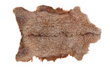 Luxurious Angora throw pelt with natural light brown curly wool texture.