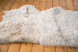 New Angora throw rug featuring luxurious ivory wool and soft, shaggy texture.