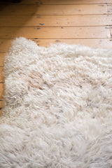 Soft, fluffy angora wool throw rug in a luxurious creamy white texture.