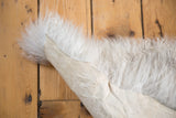 Fluffy white angora wool and natural hide backing of the luxurious throw.
