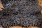 Luxurious fluffy angora wool throw rug with rich dark brown and grey texture.