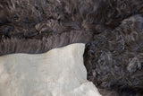 Fluffy dark grey angora wool pelt, showcasing its soft pile and smooth light backing.