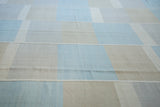 Kilim carpet with decorative horizontal seaming, light blue, ivory, beige block pattern.