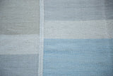 New Kilim carpet: light blue, ivory, beige block pattern and decorative seam.