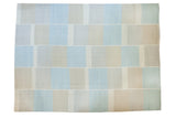 New Kilim carpet with alternating block pattern and horizontal seaming in light blue, ivory, beige.