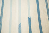 Detail of hand woven Kilim carpet featuring unique soft blue and white stripes.