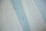 Hand-woven Egyptian wool kilim texture, with abstract ivory and powder blue channels.