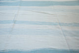 Abstract blue and ivory channels of water design on the modern hand-woven kilim.