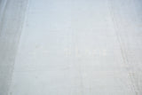 Platinum white, hand-seamed vintage hemp kilim with flat-woven texture and faint markings.