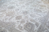 Distressed vintage Sivas carpet, sprawling silver and beige palmettes on a white field, unique texture.