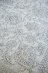 Vintage Sivas carpet's distressed texture showing exposed foundation and silver palmette design.