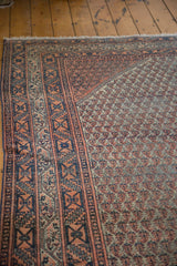 Faded blue borders and light red allover pattern on a distressed Mir Serbend rug.
