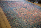 Vintage Heriz carpet showing distressed rose and charcoal blue allover compartmentalized design.