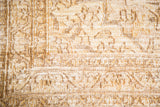 Intricate bronze, gold, and antique ivory pattern with visible foundation on distressed Khorossan rug.