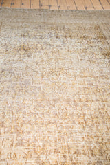 Detailed view of distressed Khorossan carpet texture, revealing bronze, gold, and ivory patterns.