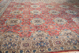 Vintage Birjand carpet's detailed traditional border and softened floral field in red and aqua.