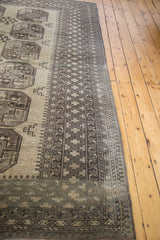 Intricate geometric borders in charcoal and grey on a vintage hand-knotted Afghani carpet.