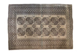 Vintage Afghani Ersari carpet with repeating geometric guls in charcoal and grey on a light camel field.