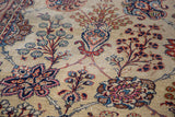 Blossoming planter vase motif in ruby, navy, and beige on a distressed Kazvin rug.