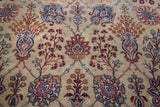 Distressed Kazvin rug showcasing ruby palmettes, blossoming planters, and navy scrolling vines.