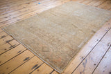 Distressed sandy bronze vintage Malayer rug corner, showing subtle tone-on-tone patterns.