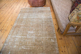 Distressed vintage Malayer rug with sandy bronze tones and subtle tone-on-tone pattern.