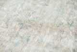 Blanched beige and faded blue intricate pattern on this distressed Tabriz rug.