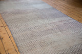 Distressed vintage Oushak runner displaying intricate harlequin pattern with neutral beige, grey, mauve tones.