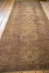 Vintage Oushak runner with distressed pile and geometric border in bronze and chestnut tones.