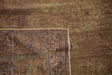 Distressed Oushak runner corner showing geometric border, fringe, and aqua overdyed tones.