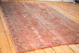 Distressed rose Oushak carpet with Caucasian-style blue and charcoal motifs.