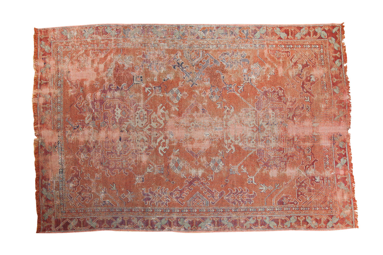 Distressed Oushak carpet in rose with faded oversize dragon motifs and blue highlights. 5'4