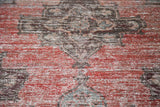 Worn texture of distressed Oushak runner, with faded rose and geometric patterns.