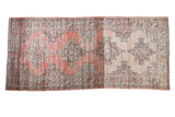 Distressed Oushak runner with large geometric medallions, rose grapefruit field, and faded tones.
