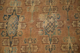 Visible wear and repeating tribal gul motifs in muted terracotta, teal, and tan on antique Yomud.