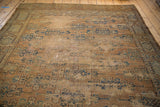 Antique Yomud tribal carpet corner, featuring blue geometric guls on distressed tan ground, visible foundation.