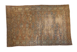 Collectible antique Yomud carpet, intricate geometric guls, distressed terracotta, and faded blue.