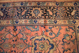 Vintage Mahal carpet corner featuring rose field, teal leaves, navy, and beige border.