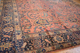 Intricate navy border of vintage Mahal carpet with rose field and teal serrated leaves.