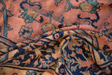 Folded pile close-up of 1920's Mahal rug, revealing rose, navy, teal palmette patterns.