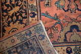 Folded corner of vintage Mahal rug, showing rose field, intricate palmettes, and hand-knotted foundation.