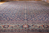 Vintage distressed Tabriz carpet with dark navy Herati field and time-softened copper green border.