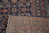 Distressed vintage Tabriz Herati pattern, dark navy with rust red details, showing reverse knotting.