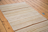 Vintage inspired kilim rug with ivory and bronze striped flatweave texture.