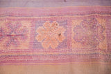 Faded peach decorative motif and striated mauve tones on hand-woven vintage Kilim.