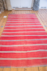 Textured bands of rich red, ivory, and mauve on this Moroccan Kilim.