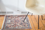 Dense weave of a vintage Bidjar rug with faded copper, aqua, and navy blue floral motifs.