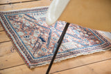 Vintage Bidjar rug corner, showcasing faded copper field, navy blue border, and aqua floral patterns.