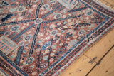 Intricate floral and stylized animal motifs on a dense vintage Persian Bidjar rug pile.