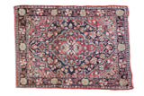 Vintage hand-knotted Sarouk rug with dark blue field, cherry red quatrefoil medallion, 2' x 2'4